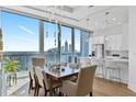 Sunlit dining area with a large table, city views, and modern lighting at 1080 Peachtree Ne St # 3507, Atlanta, GA 30309