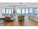 Open concept living and dining area boasting wood floors and floor-to-ceiling windows at 1080 Peachtree Ne St # 3507, Atlanta, GA 30309