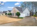 A nice angle of the house featuring a two-car garage with a concrete driveway at 3130 Goldmist Dr, Buford, GA 30519