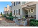 Inviting front porch with seating area, stone walkway, and beautiful landscaping at 261 Thompson St, Alpharetta, GA 30009