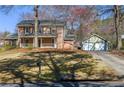 Traditional two-story home with a spacious front lawn and separate two-car garage at 4210 Gladney Dr, Atlanta, GA 30340