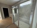 Tiled glass-enclosed shower, dual sink vanity, and natural light in the luxurious bathroom at 138 Laurel Farms Ln, Dallas, GA 30157