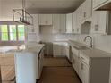 Bright new kitchen with white cabinets, a center island, pendant lighting, and stainless steel appliances at 138 Laurel Farms Ln, Dallas, GA 30157
