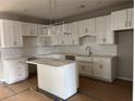 Bright kitchen features white cabinets, a center island, pendant lighting and stainless steel appliances at 138 Laurel Farms Ln, Dallas, GA 30157