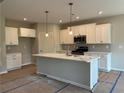New kitchen featuring white cabinets, marble countertops, and stainless steel appliances at 125 Laurel Farms Ln, Dallas, GA 30157