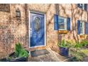 Inviting blue front door with decorative glass, flower boxes, and brick facade, adding to the home's curb appeal at 2736 Old Norcross Rd, Tucker, GA 30084