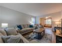 Bright living room features comfortable seating, a stylish rug, and a view into another room at 2736 Old Norcross Rd, Tucker, GA 30084