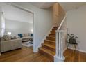 Staircase with hardwood steps, white railing, and adjacent living space creates a flowing floor plan at 2736 Old Norcross Rd, Tucker, GA 30084