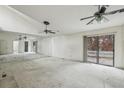 Open living room area with large mirrors, ceiling fans, and sliding glass doors to back deck at 2010 Barnes Mill Rd, Marietta, GA 30062