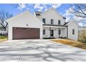 Charming two-story home with a two-car garage, fresh landscaping, and a paved driveway at 2801 Univeter Rd, Canton, GA 30115