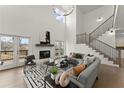 Spacious living room with high ceilings, fireplace, modern staircase, and outdoor access at 2801 Univeter Rd, Canton, GA 30115