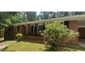 Traditional brick home with front porch and mature landscaping at 3879 Artist Vw, Decatur, GA 30034