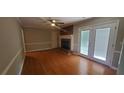 Inviting living room featuring hardwood floors, brick fireplace and French doors at 3879 Artist Vw, Decatur, GA 30034