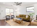 Bright living room with a modern ceiling fan, stylish furnishings, and sleek dark hardwood flooring at 1244 Lorenzo Sw Dr, Atlanta, GA 30310
