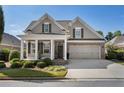 Charming home with a well-manicured lawn, a welcoming front porch, and an attached two-car garage at 3470 Serenade Nw Commons, Kennesaw, GA 30152