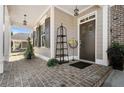 Inviting front porch featuring a brick floor and a beautifully decorated entrance at 3470 Serenade Nw Commons, Kennesaw, GA 30152