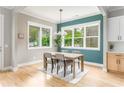 Cozy dining room featuring hardwood floors, large windows, and a stylish light fixture at 185 Marion # A, Atlanta, GA 30307