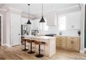 Modern kitchen with white cabinets, stainless steel appliances, a center island, and stylish pendant lighting at 185 Marion # A, Atlanta, GA 30307