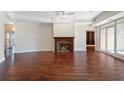 Spacious living area with a cozy fireplace, hardwood floors, and access to an outdoor terrace at 2881 Peachtree Ne Rd # 704, Atlanta, GA 30305
