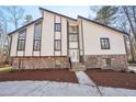 Beautiful two-story home featuring a stone base, modern siding, and expansive windows at 4013 Brenteresa Ct, Snellville, GA 30039