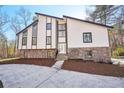 Contemporary two-story home with stone base, modern siding, and large windows at 4013 Brenteresa Ct, Snellville, GA 30039