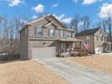 Charming two-story home with brick facade, inviting front porch, and a spacious driveway at 5160 Bucknell Trce, Cumming, GA 30028