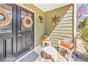 Inviting front porch with chairs, wreaths, and decorative star, creating a cozy entrance at 66 Goldrush Ne Cir, Atlanta, GA 30328
