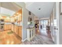 Bright hallway with wood floors and decorative cabinet, leading to the kitchen and living room at 66 Goldrush Ne Cir, Atlanta, GA 30328