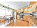 Well-lit kitchen with stainless steel appliances, breakfast nook and granite countertops at 66 Goldrush Ne Cir, Atlanta, GA 30328