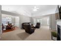 Spacious living room featuring a vaulted ceiling, fireplace, and neutral carpet at 1461 Beckley Pointe, Lawrenceville, GA 30043