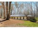 Attractive one-story home featuring a mix of stone and siding, nestled amongst mature trees and landscaping at 2145 Mountclaire Ct, Stone Mountain, GA 30087