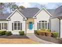 Close up of a charming single-story home with manicured lawn and a bright blue door at 25 Sherman Nw Ln, Cartersville, GA 30121