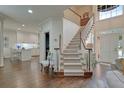 Welcoming foyer features a beautiful staircase, high ceilings and views into the modern kitchen at 155 Oakpark Ct, Mcdonough, GA 30253