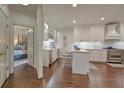 Bright kitchen featuring white cabinets, stainless steel appliances and a cozy breakfast bar at 155 Oakpark Ct, Mcdonough, GA 30253