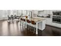 Gourmet kitchen featuring stainless steel appliances, granite countertops, a center island with seating, and pendant lighting at 1828 Falling Sky Ct, Atlanta, GA 30319