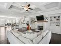 Spacious living room with coffered ceilings, fireplace, built-ins, and flows into the open kitchen at 1828 Falling Sky Ct, Atlanta, GA 30319