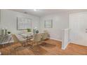 Bright dining room features modern decor, a glass table with seating for six and hardwood floors at 2201 Fairington Village Dr, Lithonia, GA 30038
