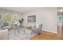 Inviting living room features modern decor, hardwood floors, a stylish rug and natural light at 2201 Fairington Village Dr, Lithonia, GA 30038