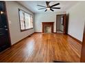 Bright living room features hardwood floors, a brick fireplace, and a large window overlooking the front yard at 461 Deckner Sw Ave, Atlanta, GA 30310