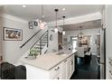 Modern kitchen with white cabinets, stainless steel appliances, kitchen island, and dark wood floors at 808 Dixie Ne Ave, Atlanta, GA 30307