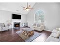 Bright living room featuring a fireplace, vaulted ceilings, and large windows at 1975 Slate Rd, Ellenwood, GA 30294