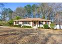A ranch style home on a lot with green landscaping featuring a welcoming front entryway at 2940 Stonecreek Se Rd, Smyrna, GA 30080