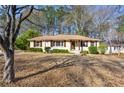 A ranch style home on a lot with green landscaping featuring mature trees at 2940 Stonecreek Se Rd, Smyrna, GA 30080