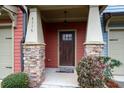 Covered front porch with stone columns, dark wood door, and manicured shrubbery at 4116 Mars Bay # 27, Acworth, GA 30101