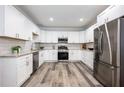 Modern kitchen with stainless steel appliances, white cabinets and granite countertops at 872 Beryl Sw St, Atlanta, GA 30310