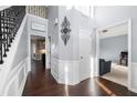 Elegant foyer with hardwood floors, wainscoting, and a staircase with iron balusters at 1191 Fountain Head Ct, Lawrenceville, GA 30043