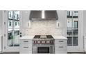 Close up of kitchen features, including stainless range and hood and white marble backsplash at 574 Boulevard Ne Pl # 5, Atlanta, GA 30308