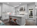 Contemporary kitchen featuring an island with seating, stainless steel appliances, and sleek white cabinetry at 574 Boulevard Ne Pl # 5, Atlanta, GA 30308