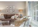 Well-lit living room showcasing a cozy sofa, patterned armchair, and large windows at 78 Paces West Nw Cir, Atlanta, GA 30327