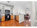 Bright, open kitchen with stainless appliances, granite counters and hardwood floors, with an open view to the living room at 375 Highland Ne Ave # 908, Atlanta, GA 30312